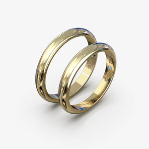 Vielsesringe i 18 kt gult guld med klassisk profil og blå diamant, produktfoto