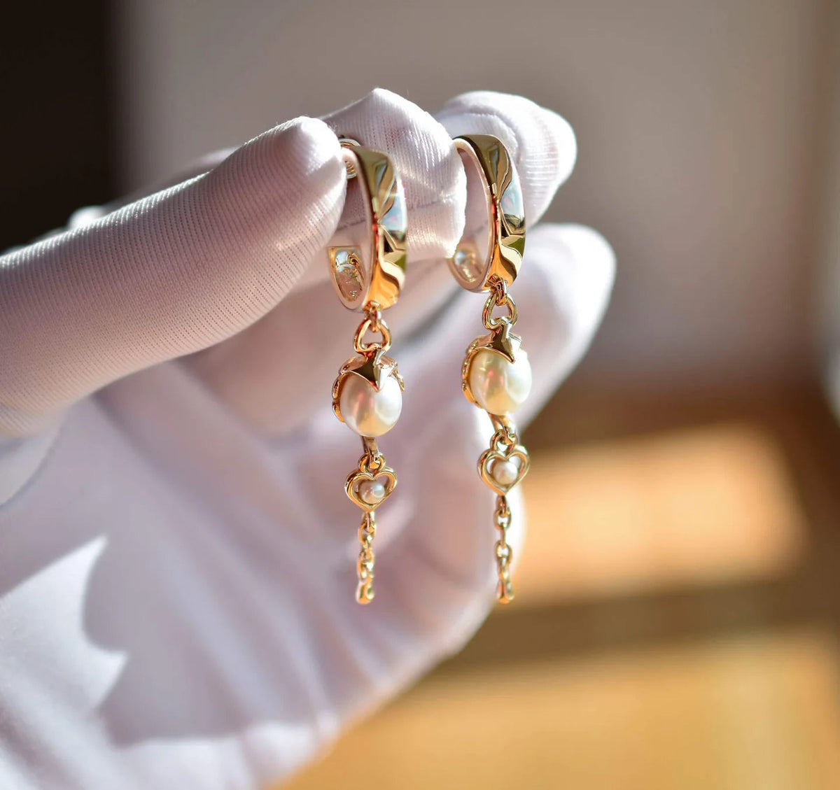 Øreringe med en stor oval og en mindre rund perle i hver — en konfirmationsgave fra bedstemor.