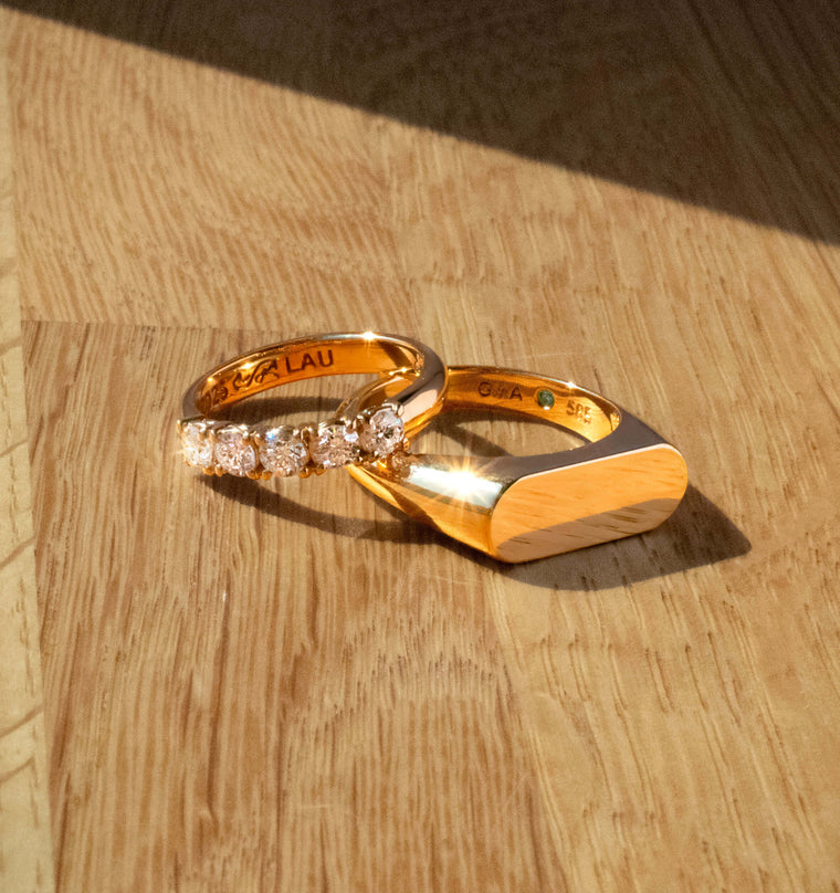 Speciallavede guldringe med diamanter, personlig gravering og grøn ædelsten